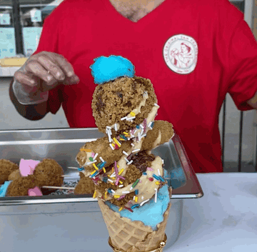 Several waffle cones of meatballs, mozzarella sticks, sprinkles and cotton candy.