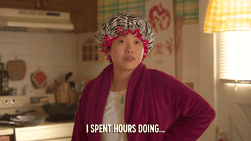 Awkwafina taking off a zebra printed shower cap while wearing a purple robe and saying &quot;I spent hours doing my hair&quot;