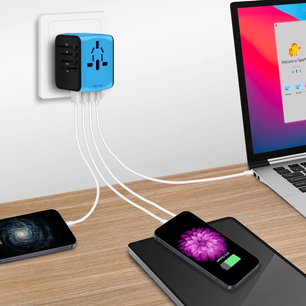 The adapter plugged into the wall and charging multiple devices