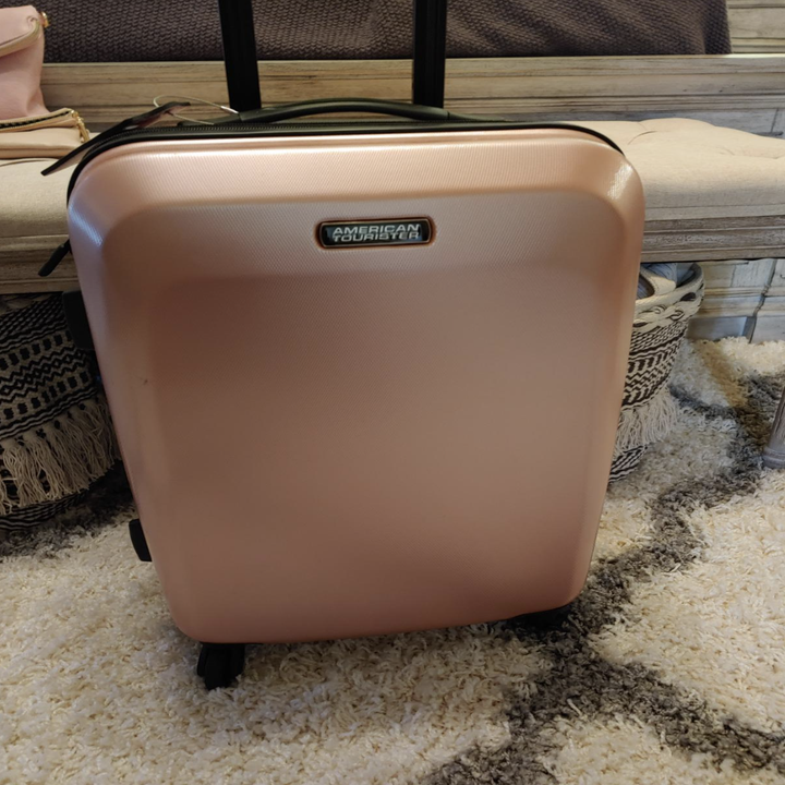 reviewer's photo of the pink suitcase