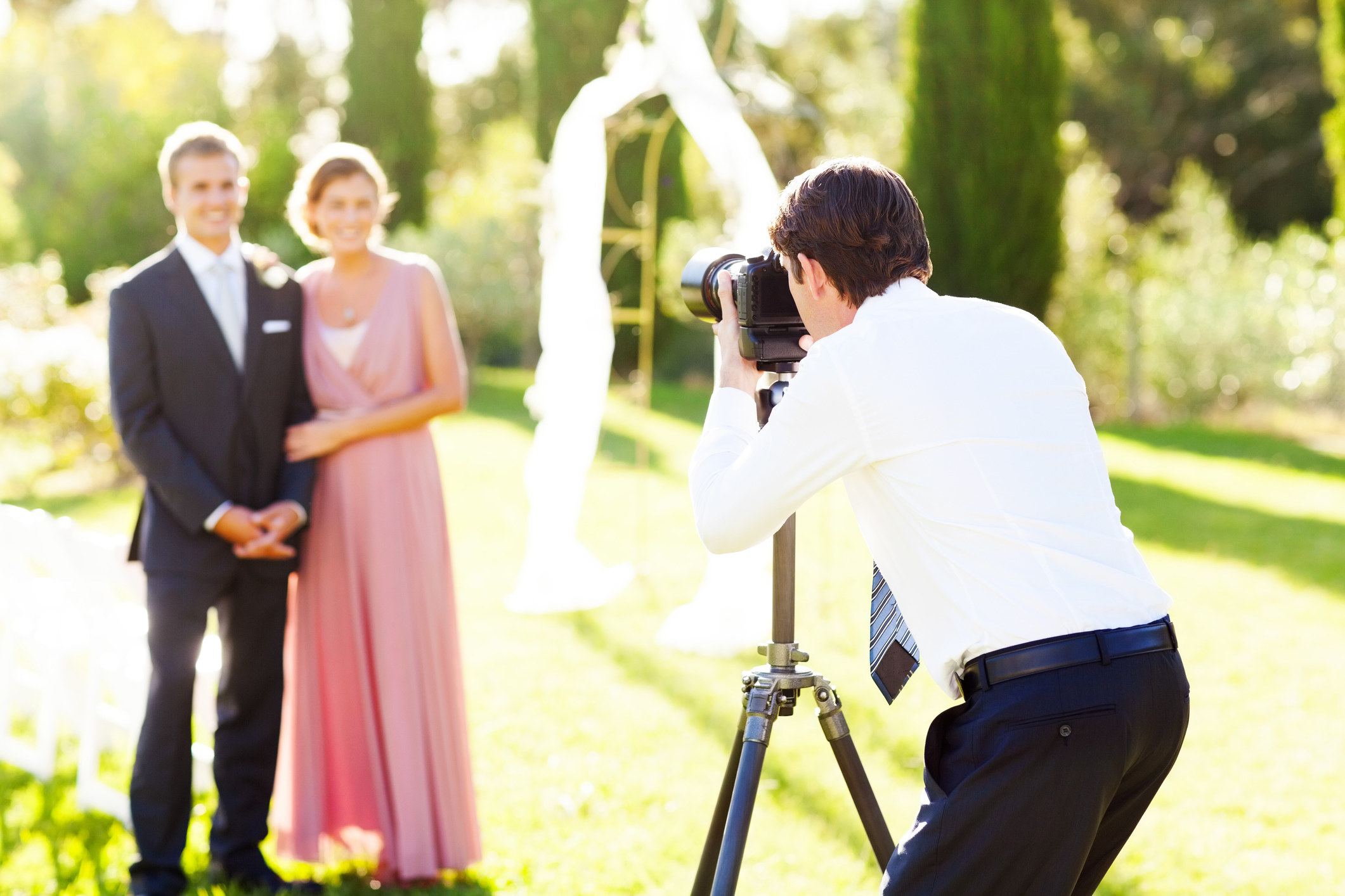 A photographer takes a picture of a couple
