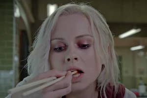 Liv from iZombie eating something with chopsticks