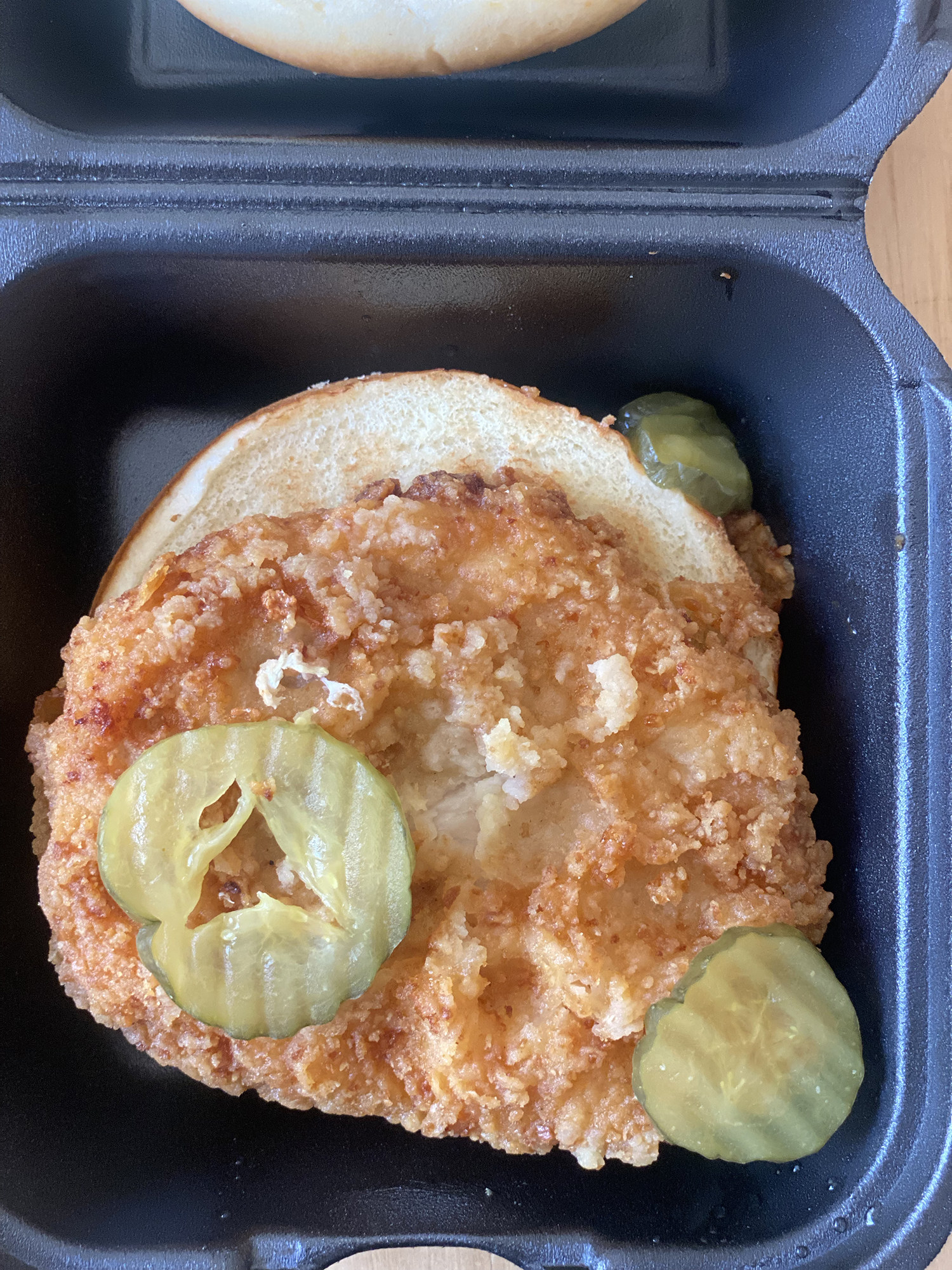 An opened chicken sandwich
