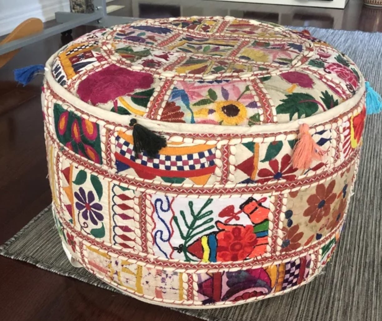 a reviewer photo of the multicolor patterned pouf