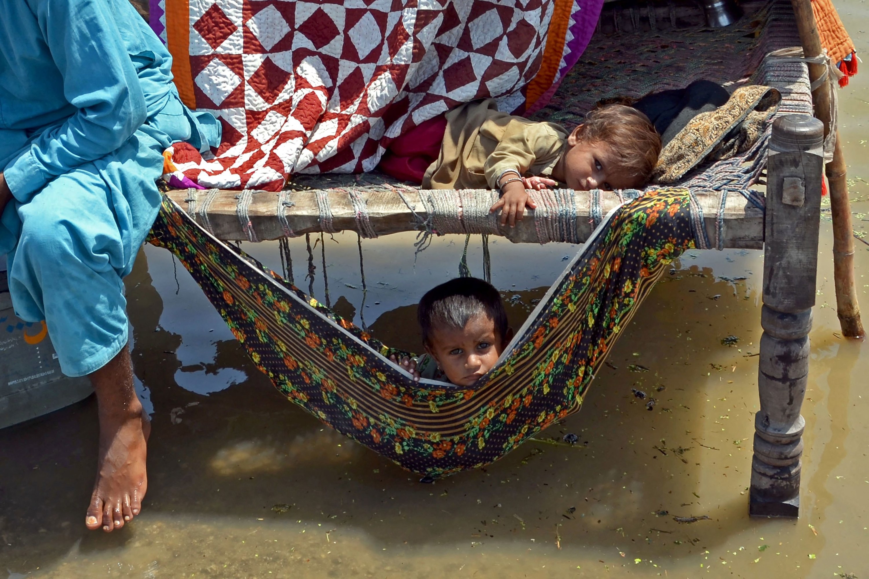 A child on a cot over water