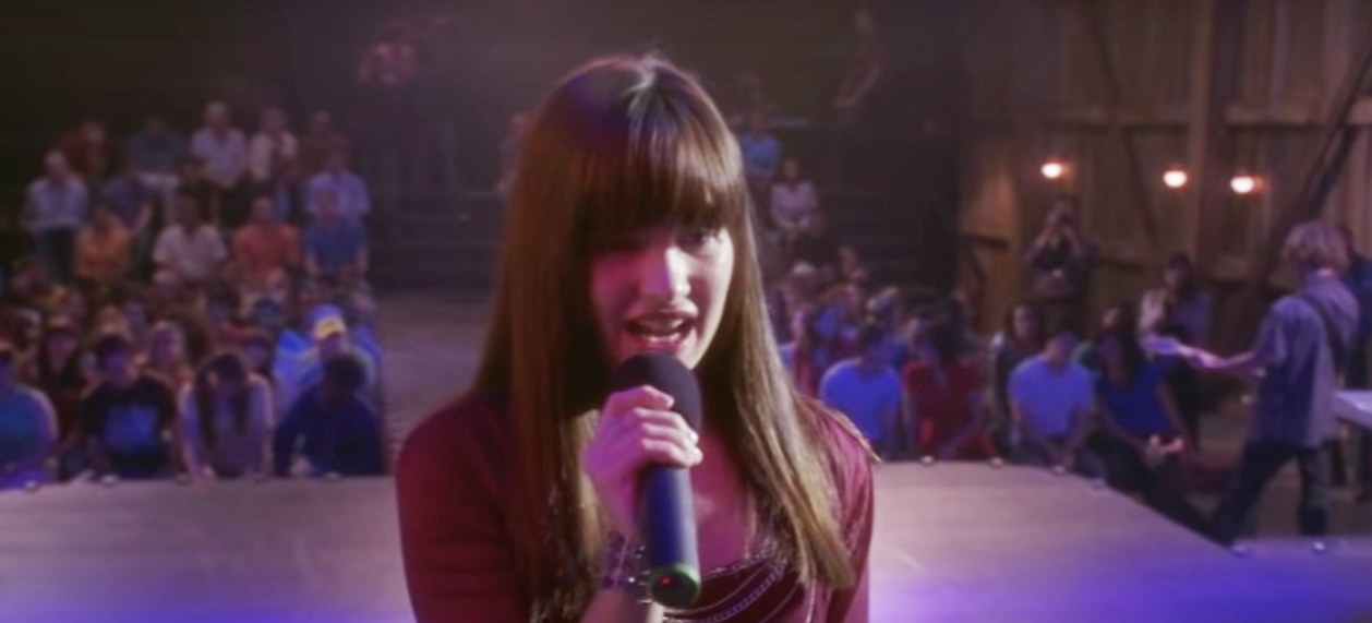 demi&#x27;s character singing on a stage