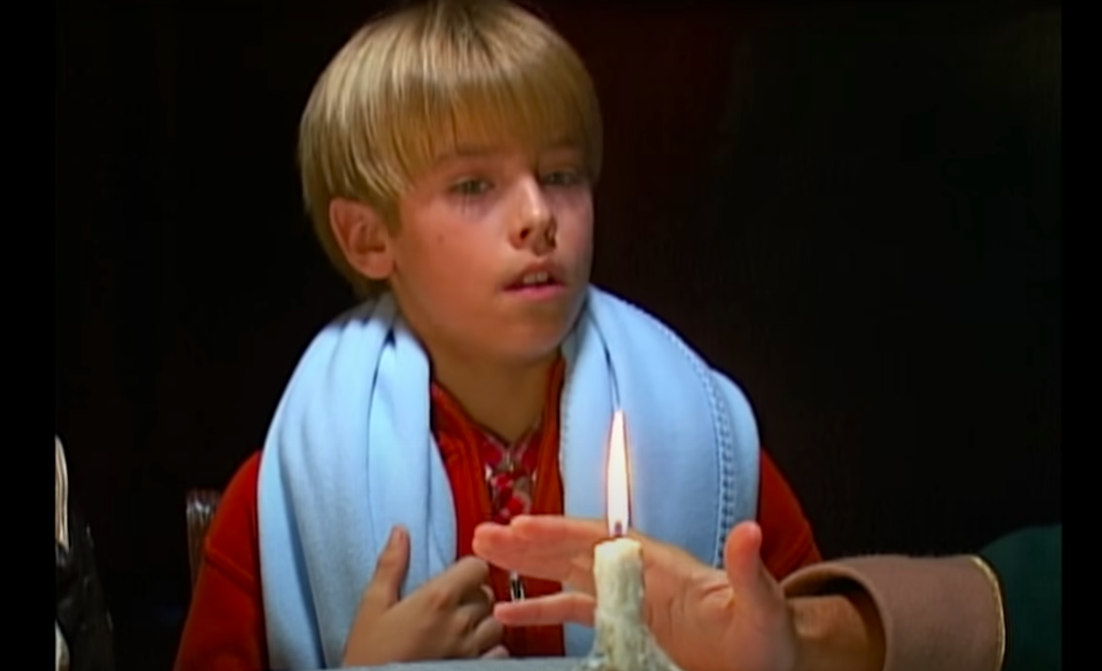 close up of cole&#x27;s character in front of a candle