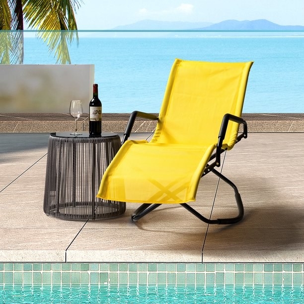 the yellow chair next to a pool