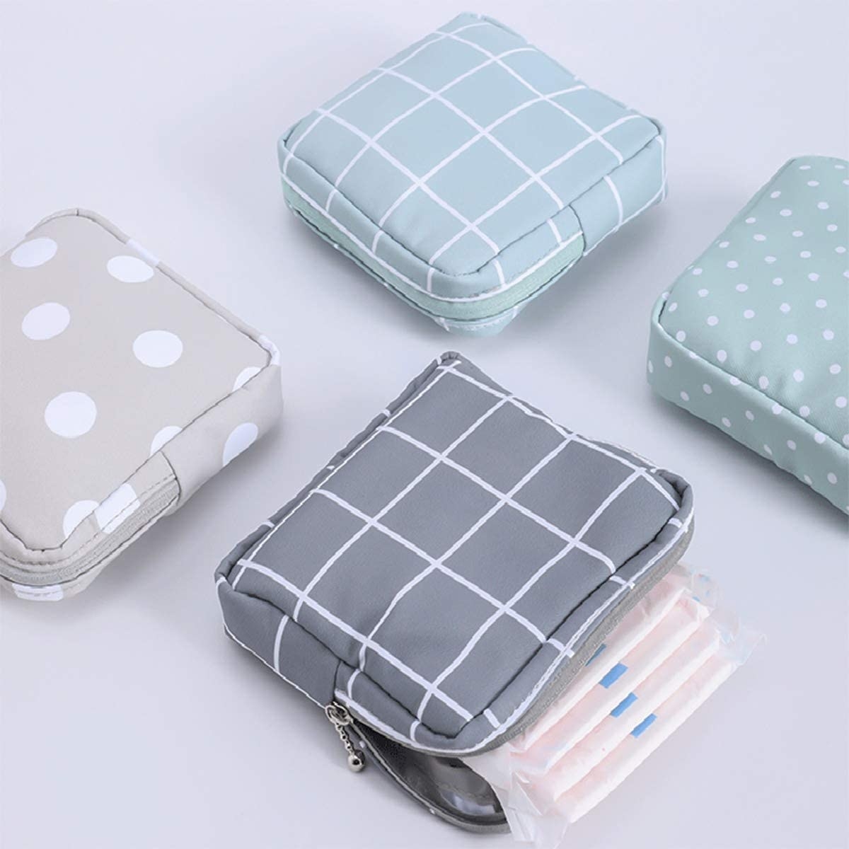 a few of the pouches on a table with pads in one of them