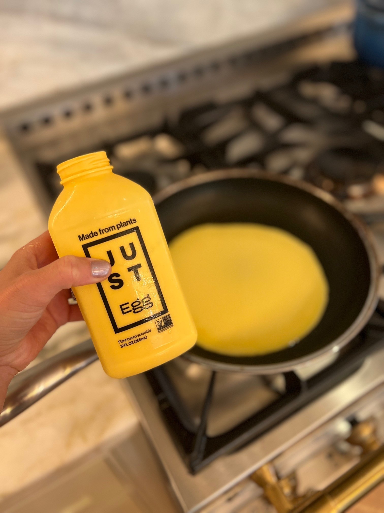 Pouring Just eggs into a skillet.