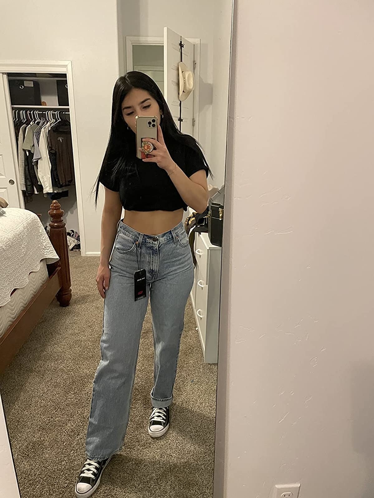 Reviewer wearing jeans and black crop top