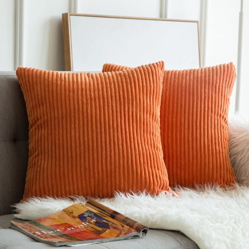 orange corduroy pillows on a couch