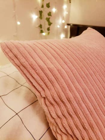 close-up of the pink pillow's soft corduroy texture
