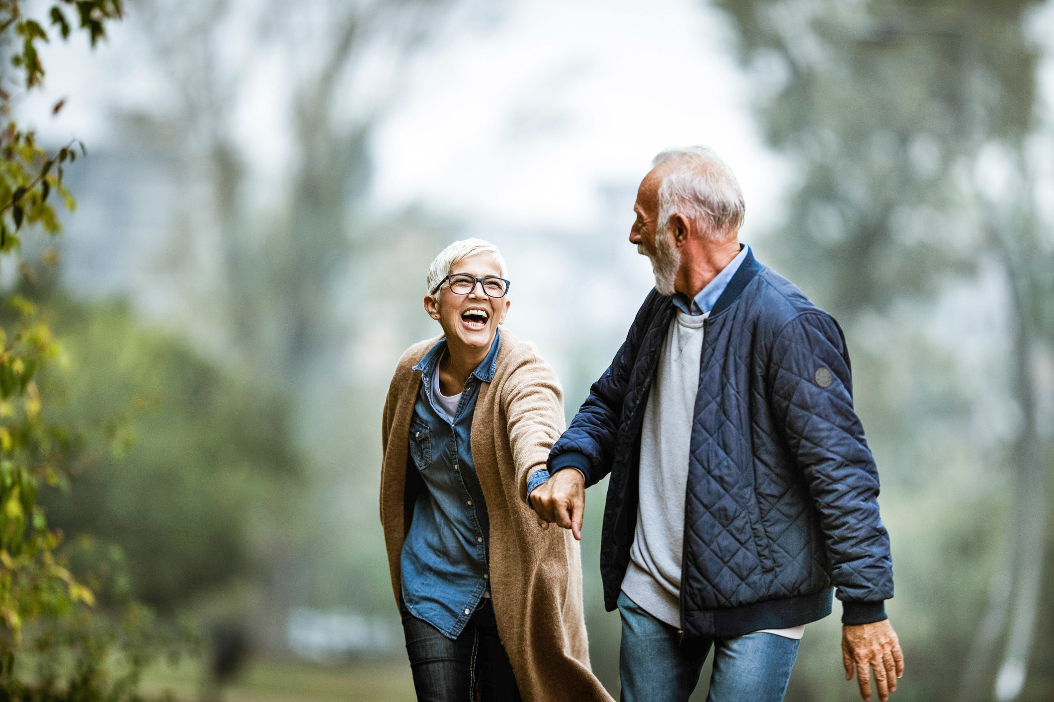 A couple walks in a park