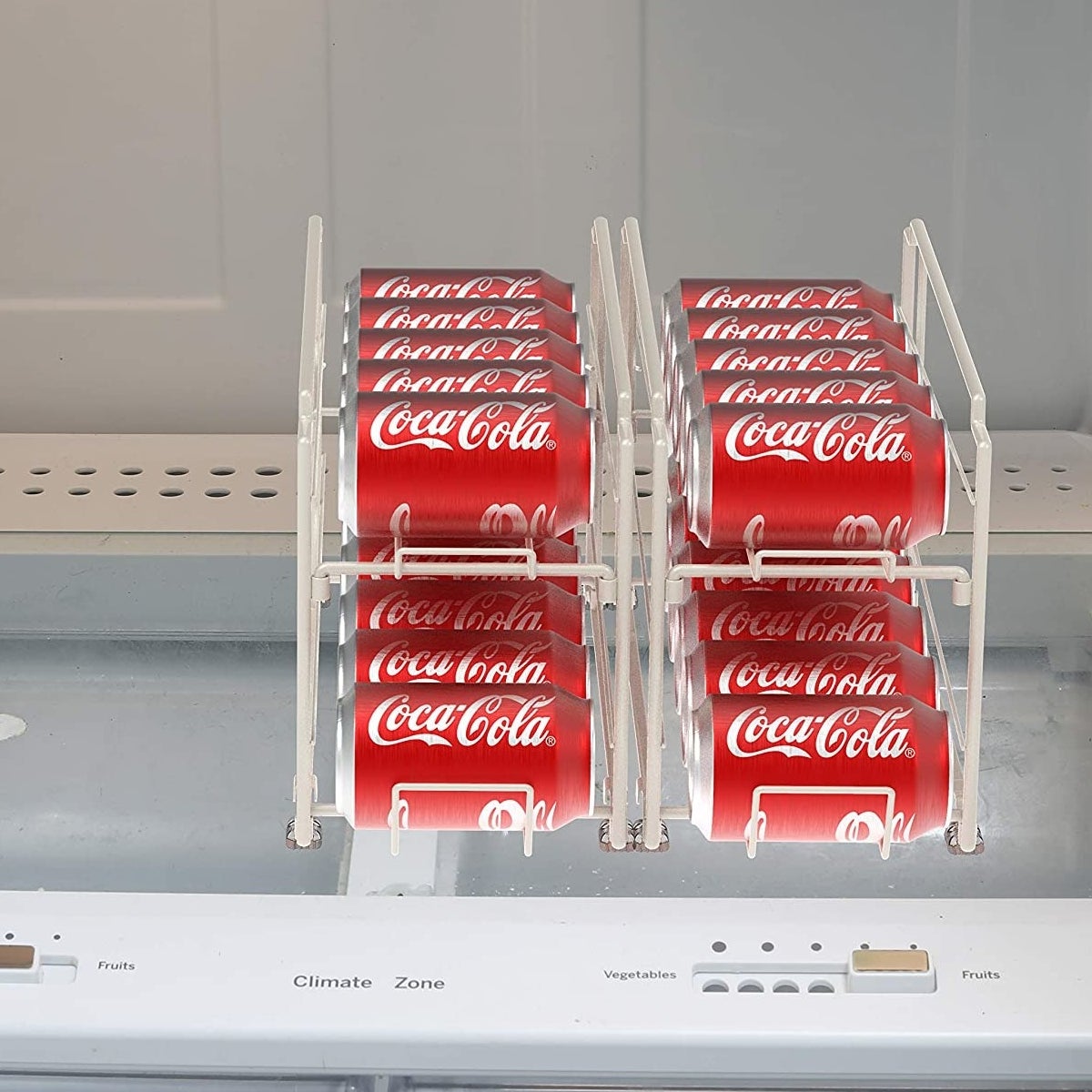 The pop can dispenser inside an empty fridge