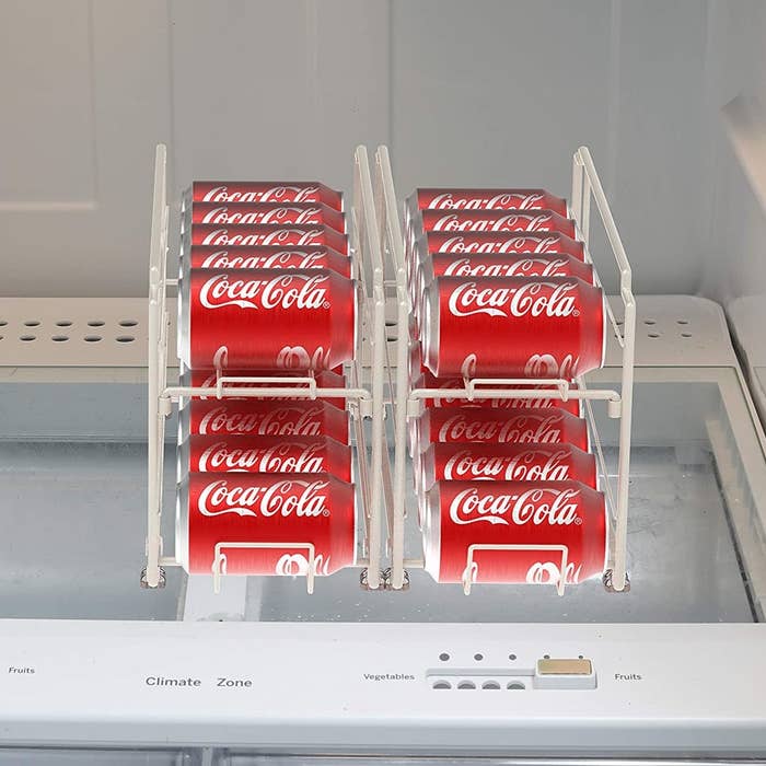 The pop can dispenser inside an empty fridge