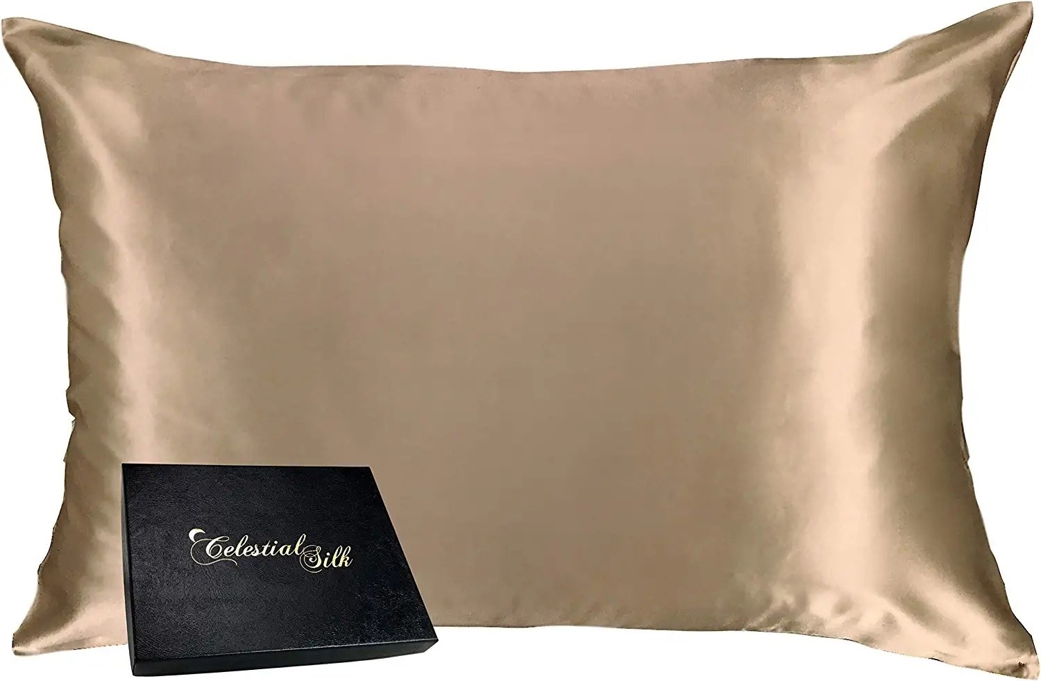 A pillow with a champagne colored silk pillowcase and a small box