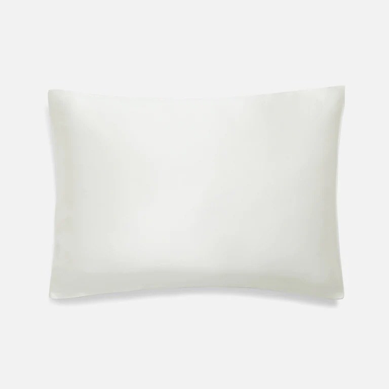 A pillow with a white silk pillowcase