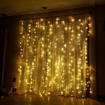 the lights hanging behind sheer curtains
