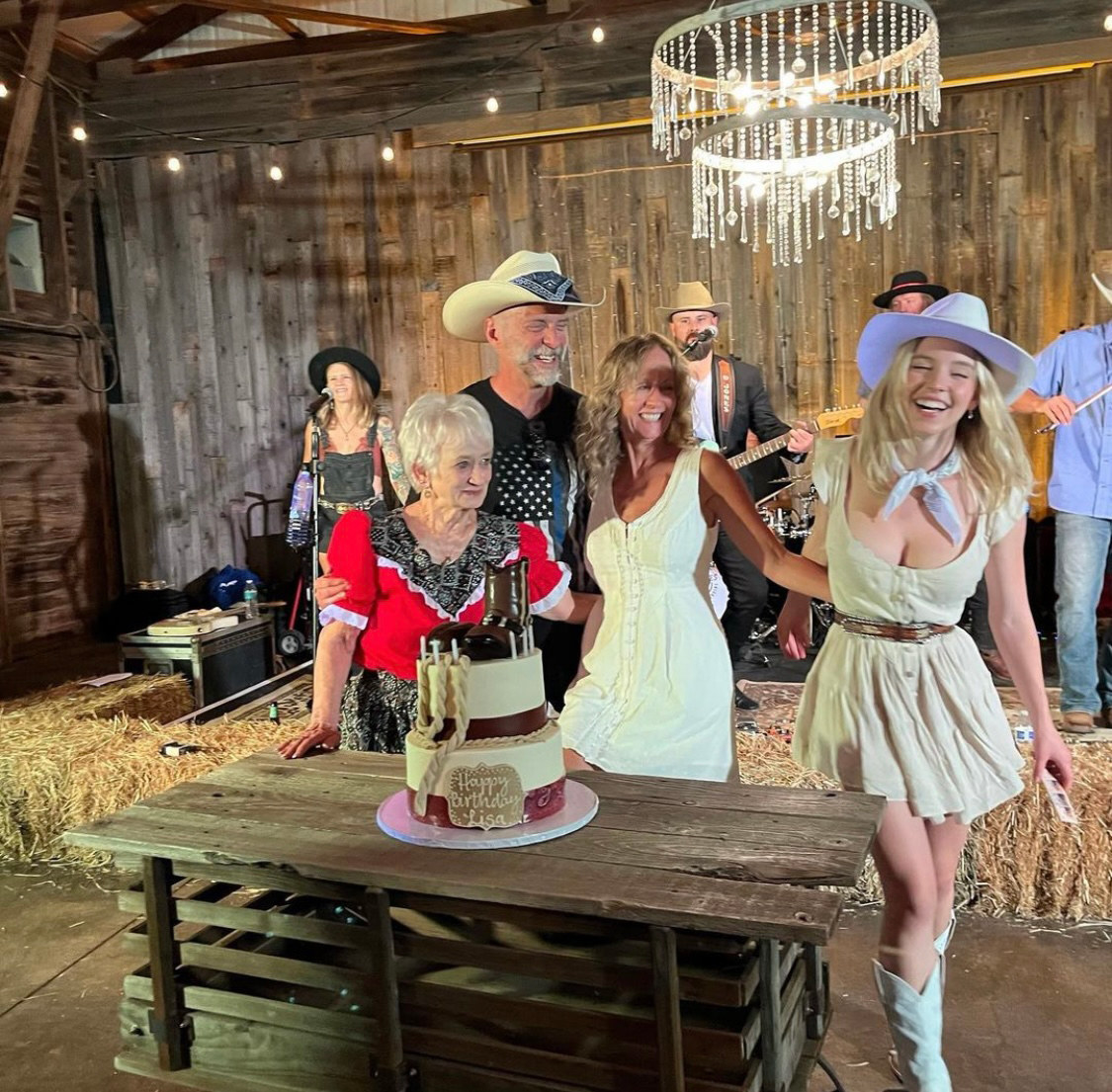 Sweeney is smiling and laughing with her family, standing behind a birthday cake, in the image she posted on Instagram in which her dad is wearing a T-shirt with the thin blue line flag on it