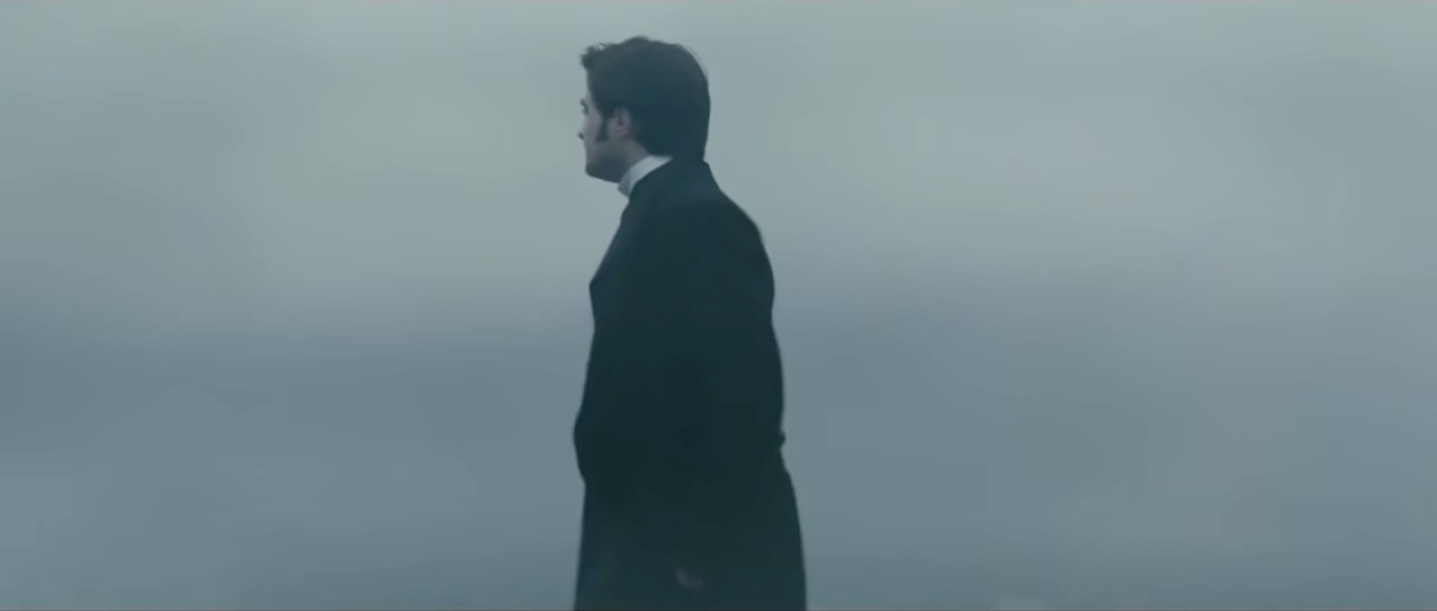 A man standing against a misty backdrop