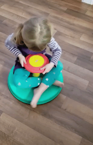reviewer's child spinning on the toy
