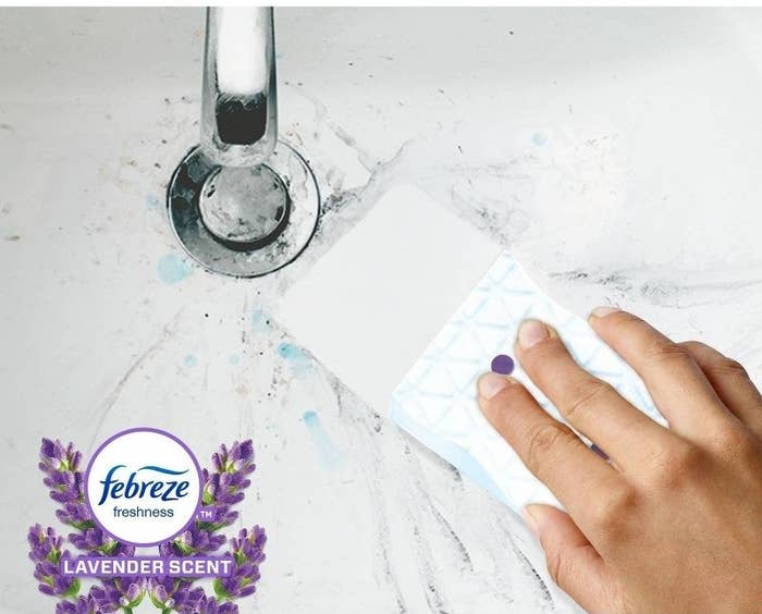 a person cleaning a sink with white magic eraser