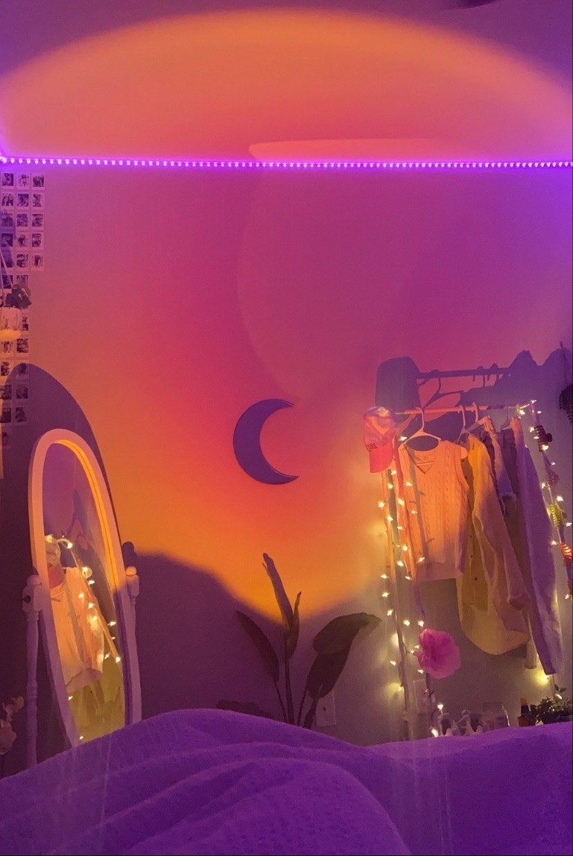 a pink/yellowish airy  formed  connected  the partition  of a reviewer's bedroom