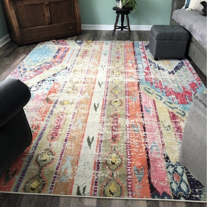 a reviewer photo of the colorful rug in a living room