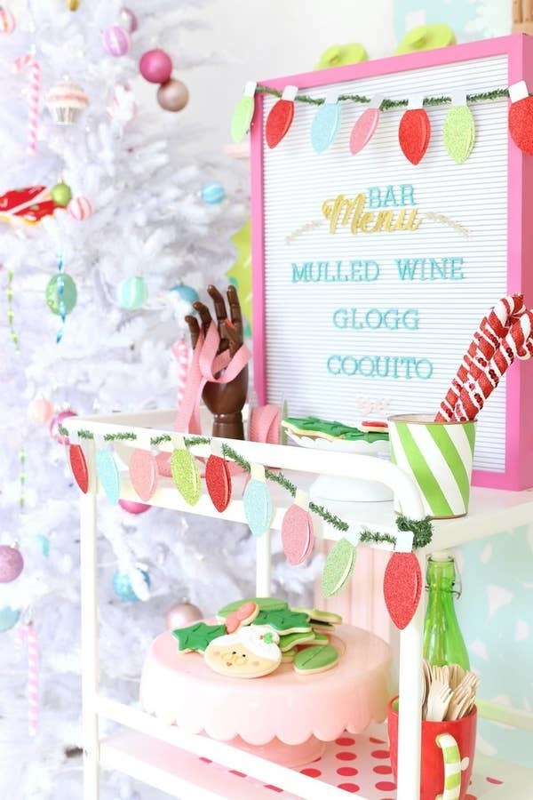 A Christmas lights paper garland hanging from a multi-tier tray