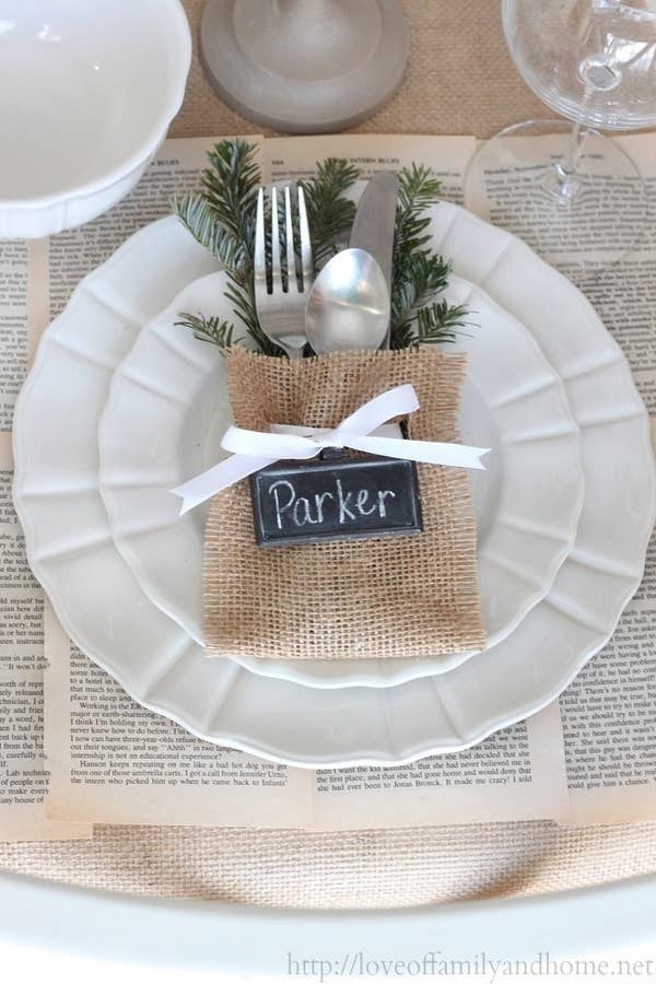 Place settings made of linen pouches with holly