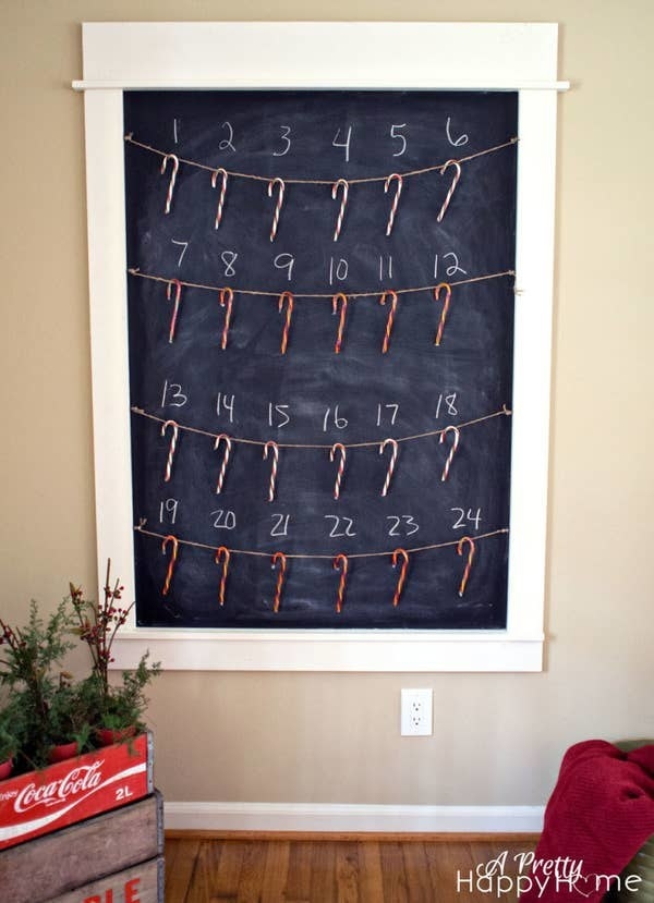 An Advent calendar on the wall with the numerals 1–24 and each one with a candy cane below it