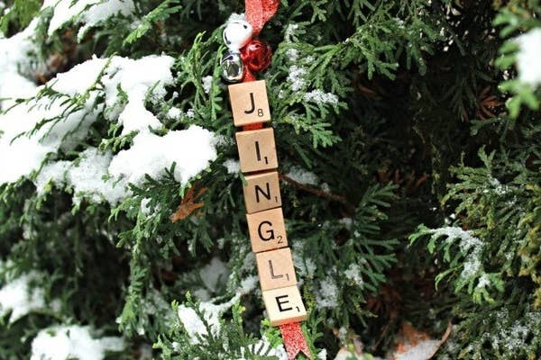 Scrabble tiles spelling &quot;Jingle&quot; hanging from a tree