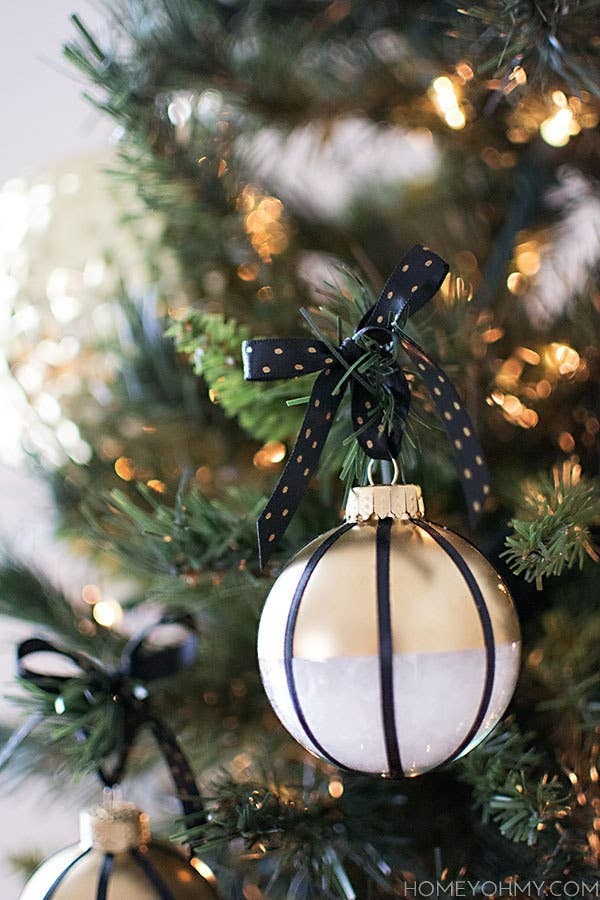 Colorblock glass ball ornaments hanging from a tree