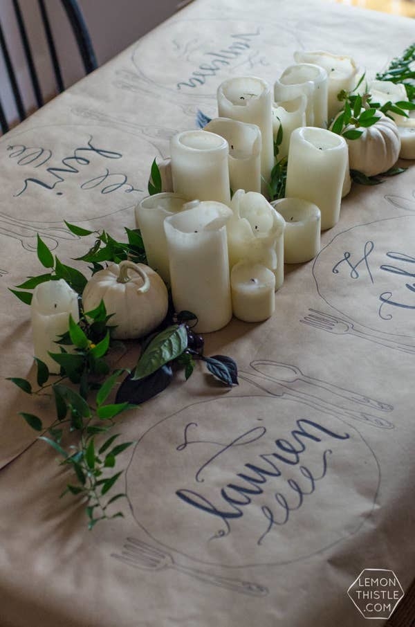 A table covered with kraft paper with writing on it and candles