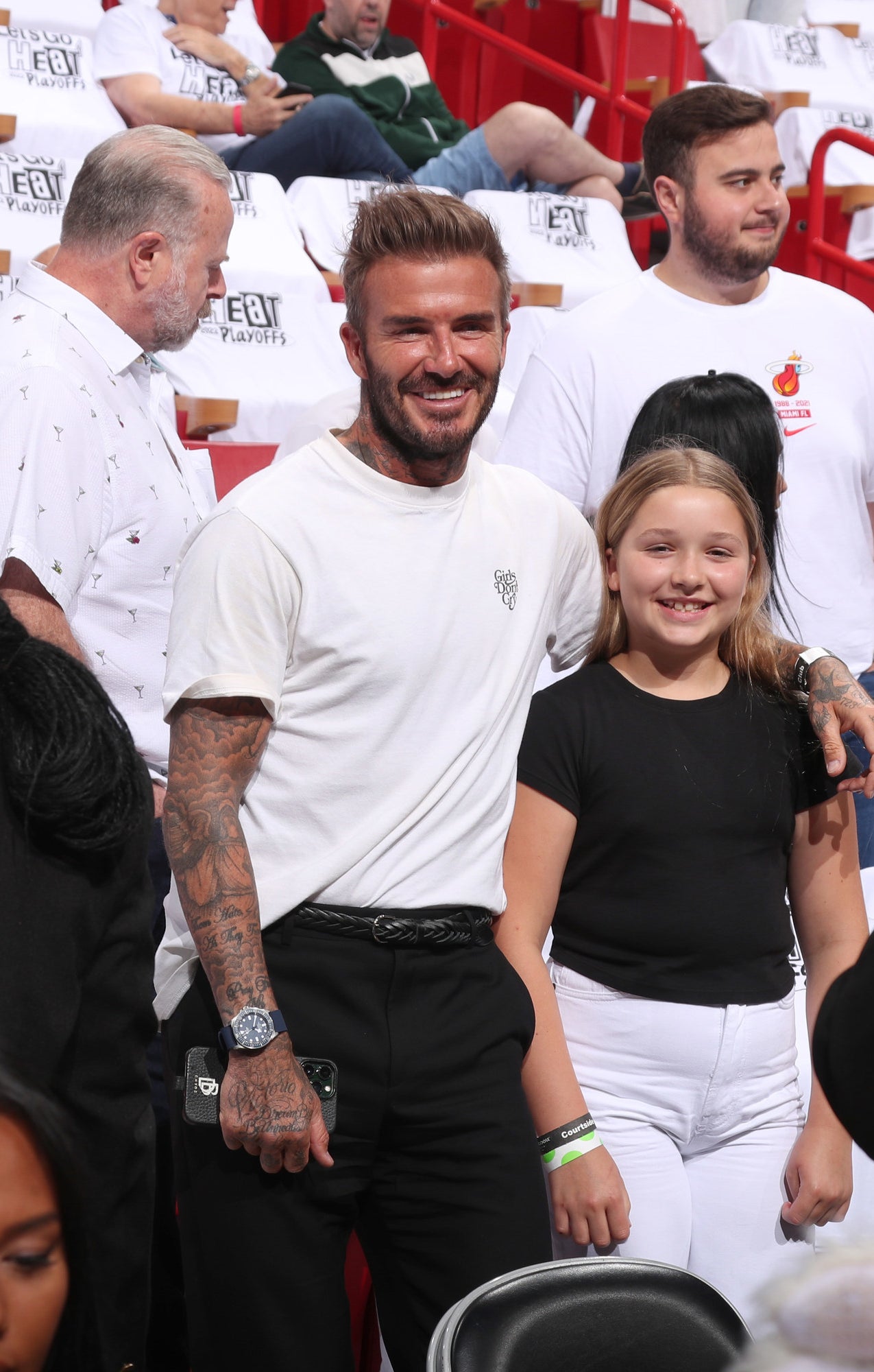 David Beckham and daughter Harper attending a Miami Heat game in black and white outfits