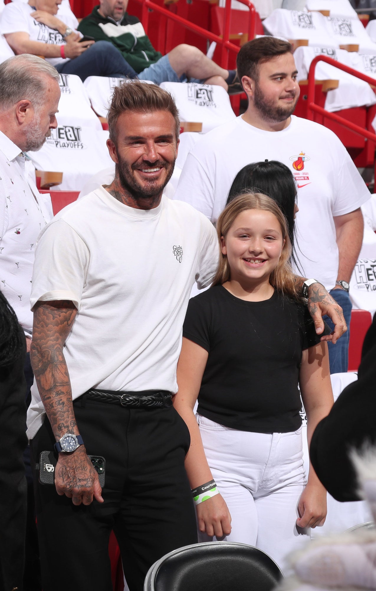 David Beckham and daughter Harper attending a Miami Heat game in black and white outfits