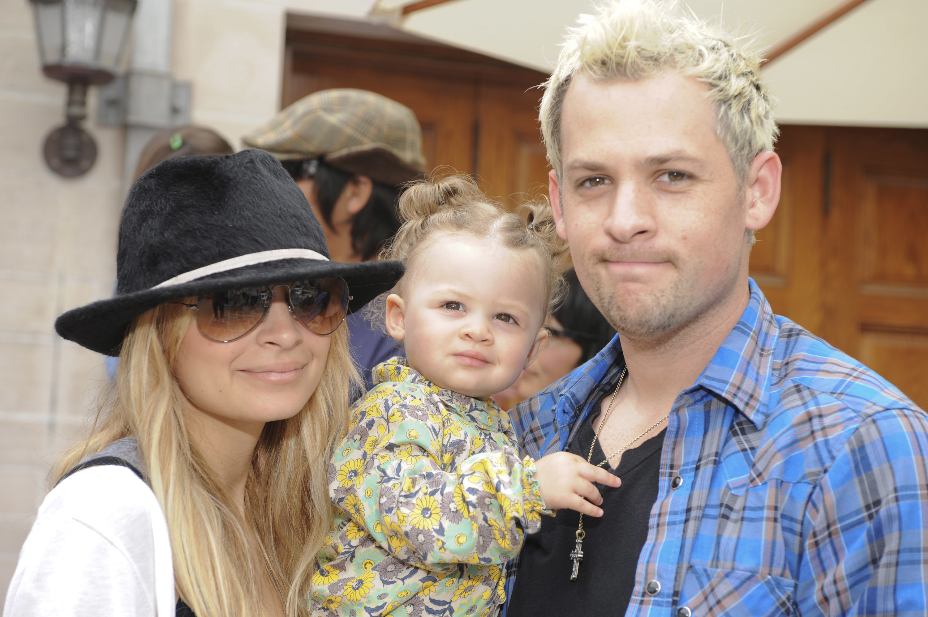 Nicole Richie posing with Joel Madden, who holds their daughter Harlow
