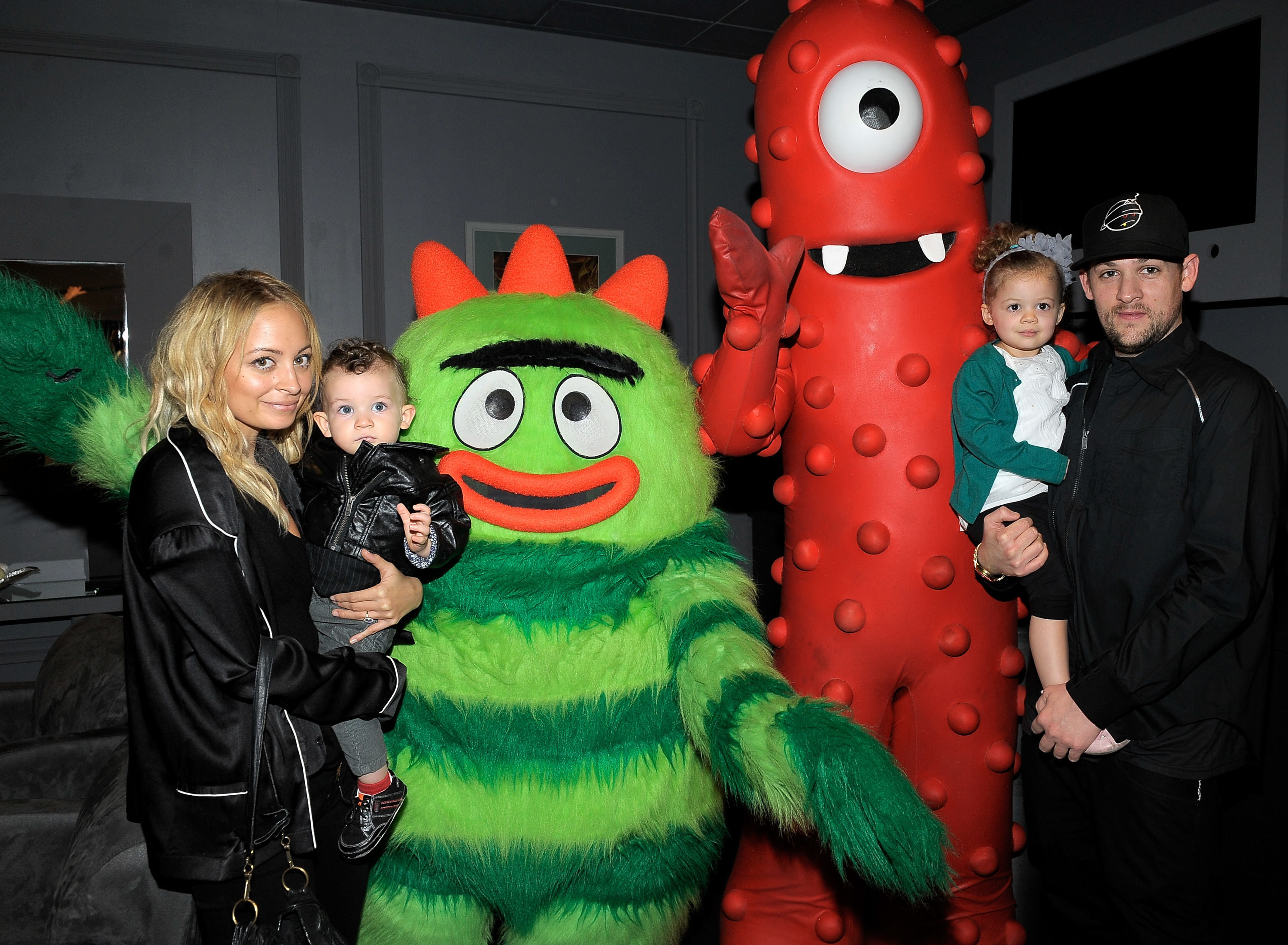 Nicole Richie, son Sparrow Madden, daughter Harlow Madden and husband musician Joel Madden pose with YO GABBA GABBA! characters