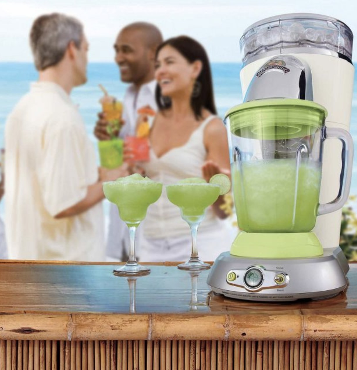 margarita machine next to two glasses with models enjoying in the background