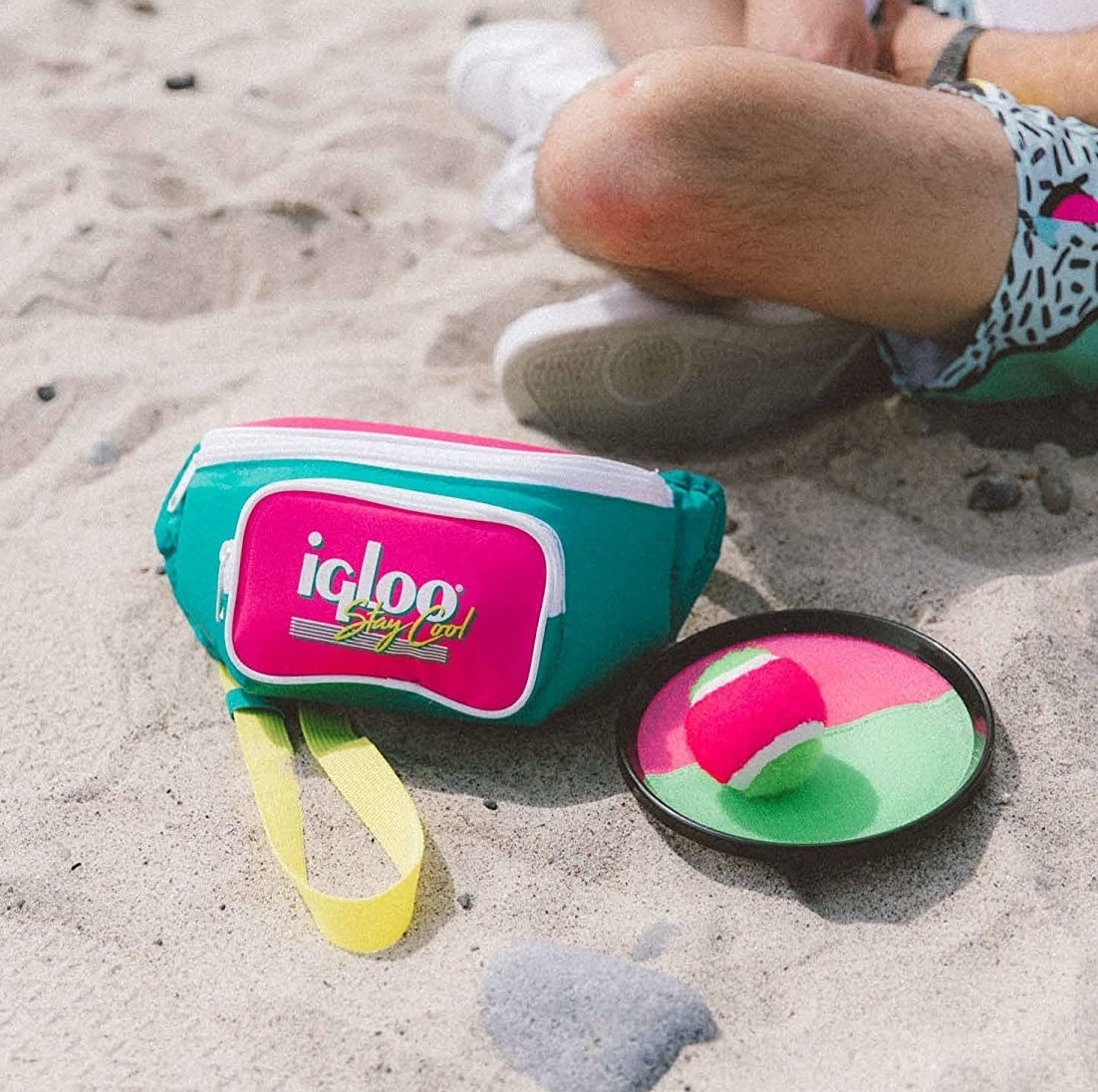 an insulated fanny pack on a beach in the sand
