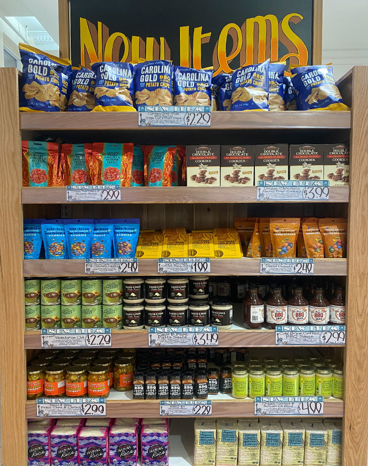 A shelf of new items at a grocery store.