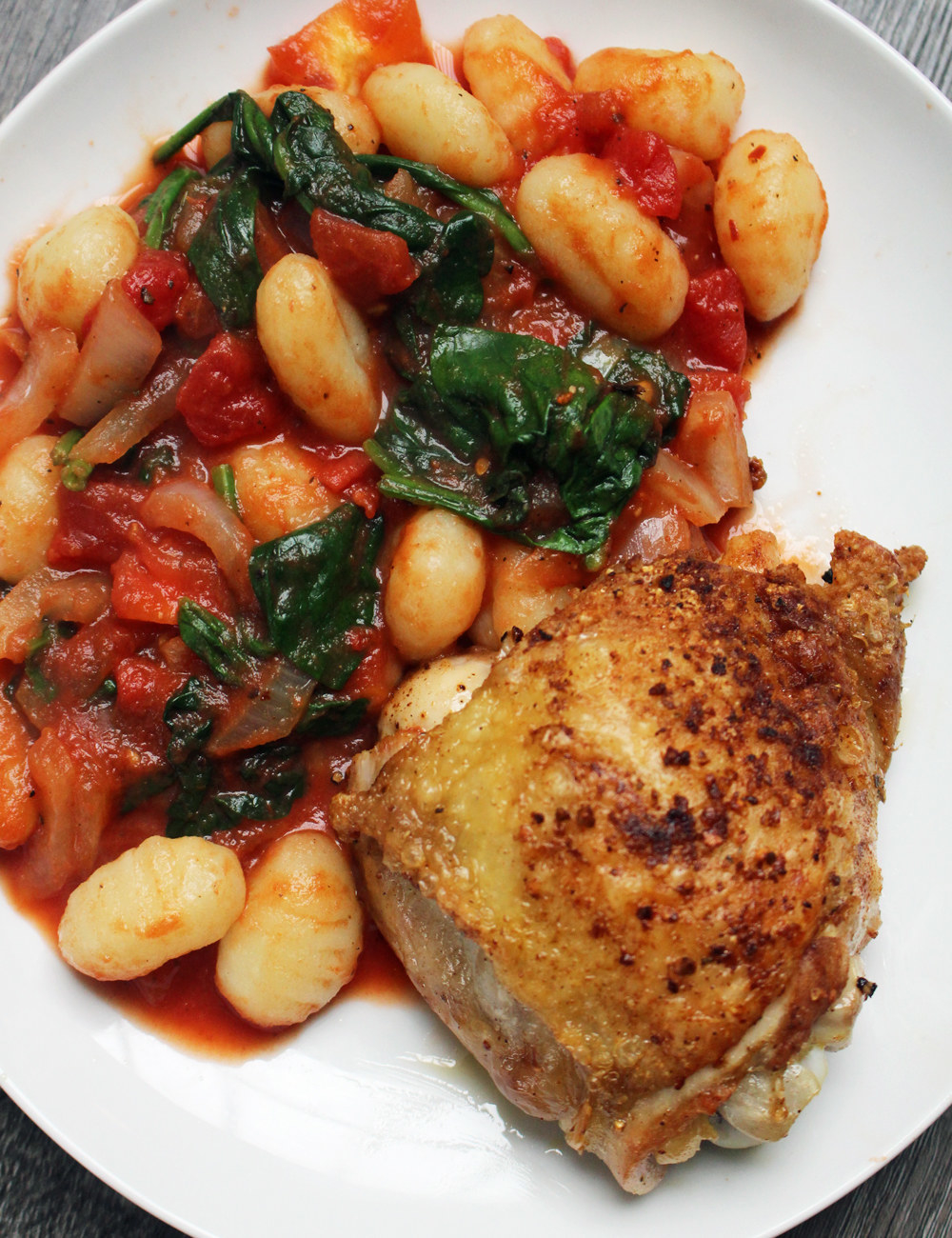A plate of chicken and gnocchi.