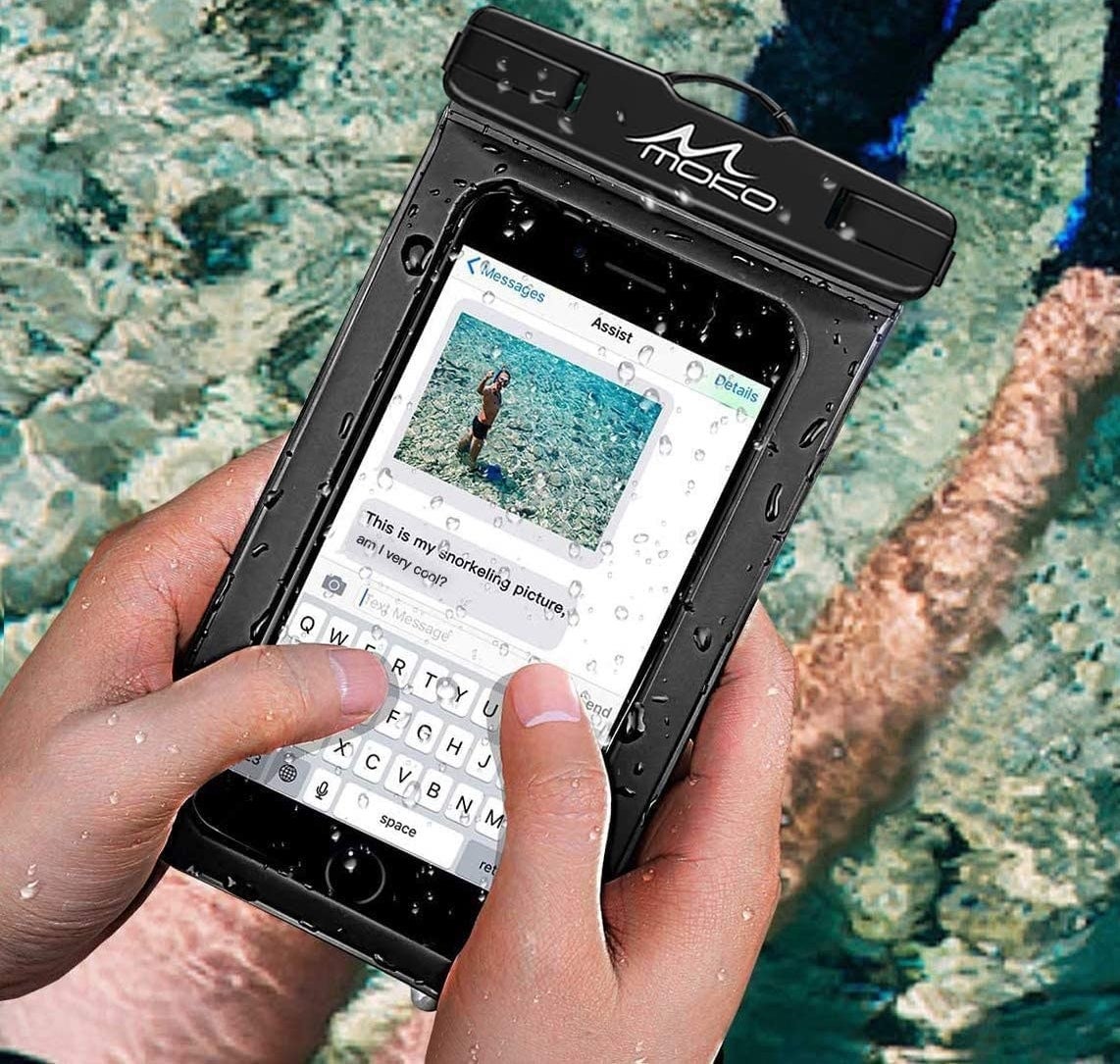 a person using their phone in the pouch while sitting in a body of water