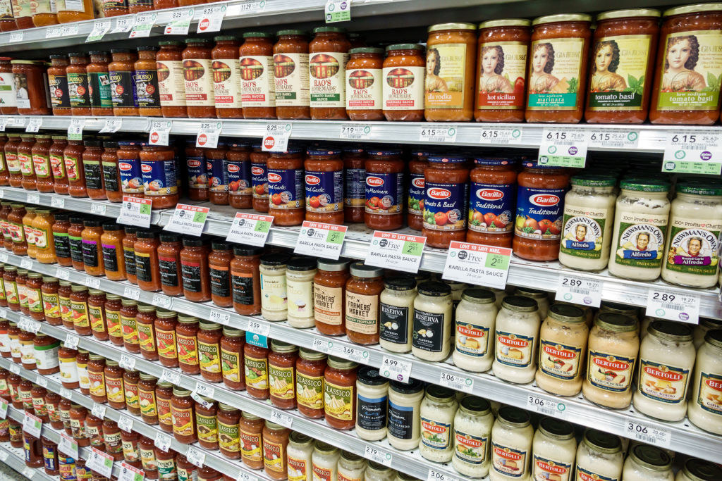 Different pasta sauces in a grocery aisle.