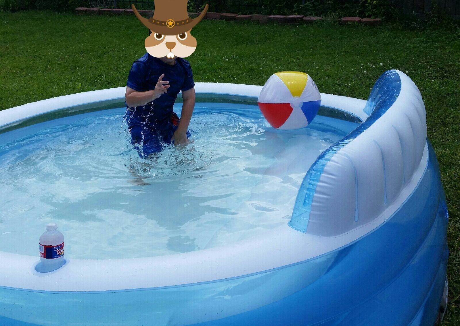 reviewer&#x27;s photo of a kid in the inflatable pool