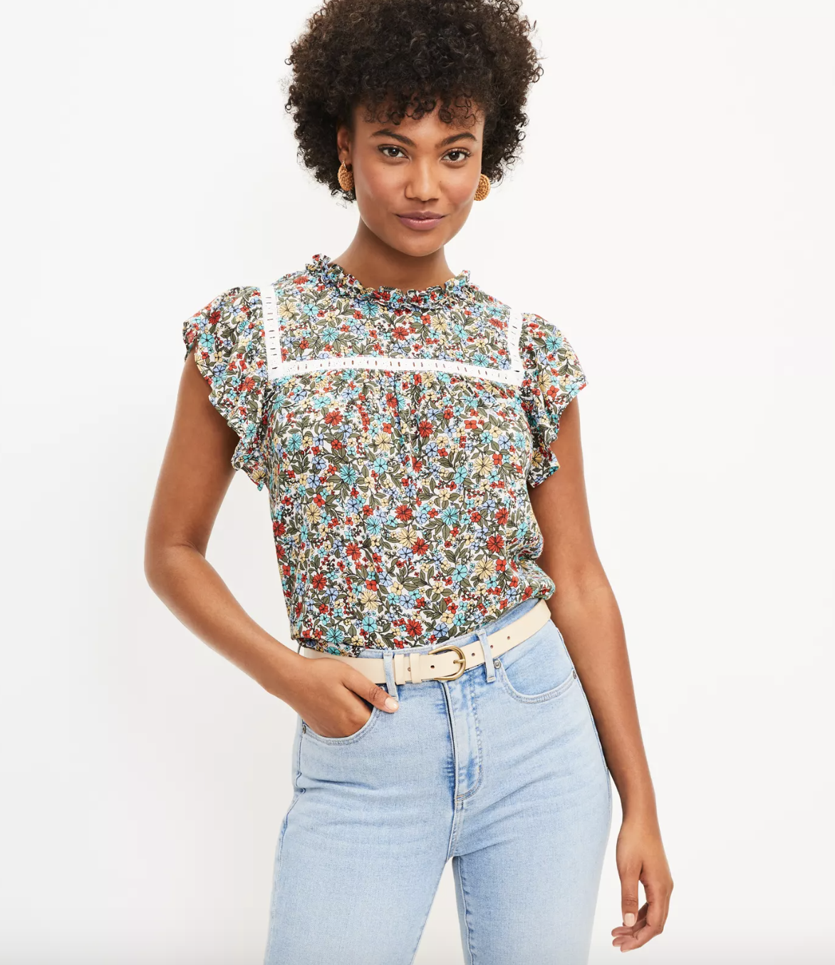 model wearing floral flutter sleeve top with high-rise light blue jeans