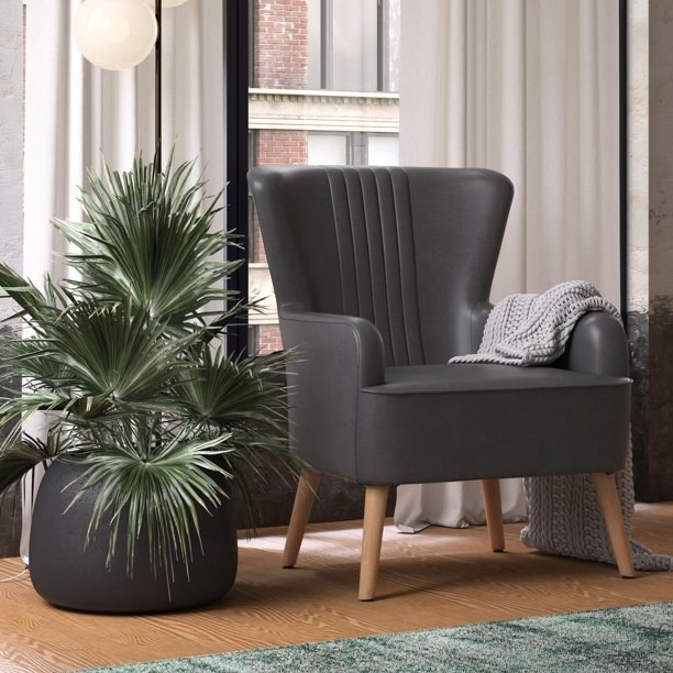 the faux leather gray accent chair in a living room