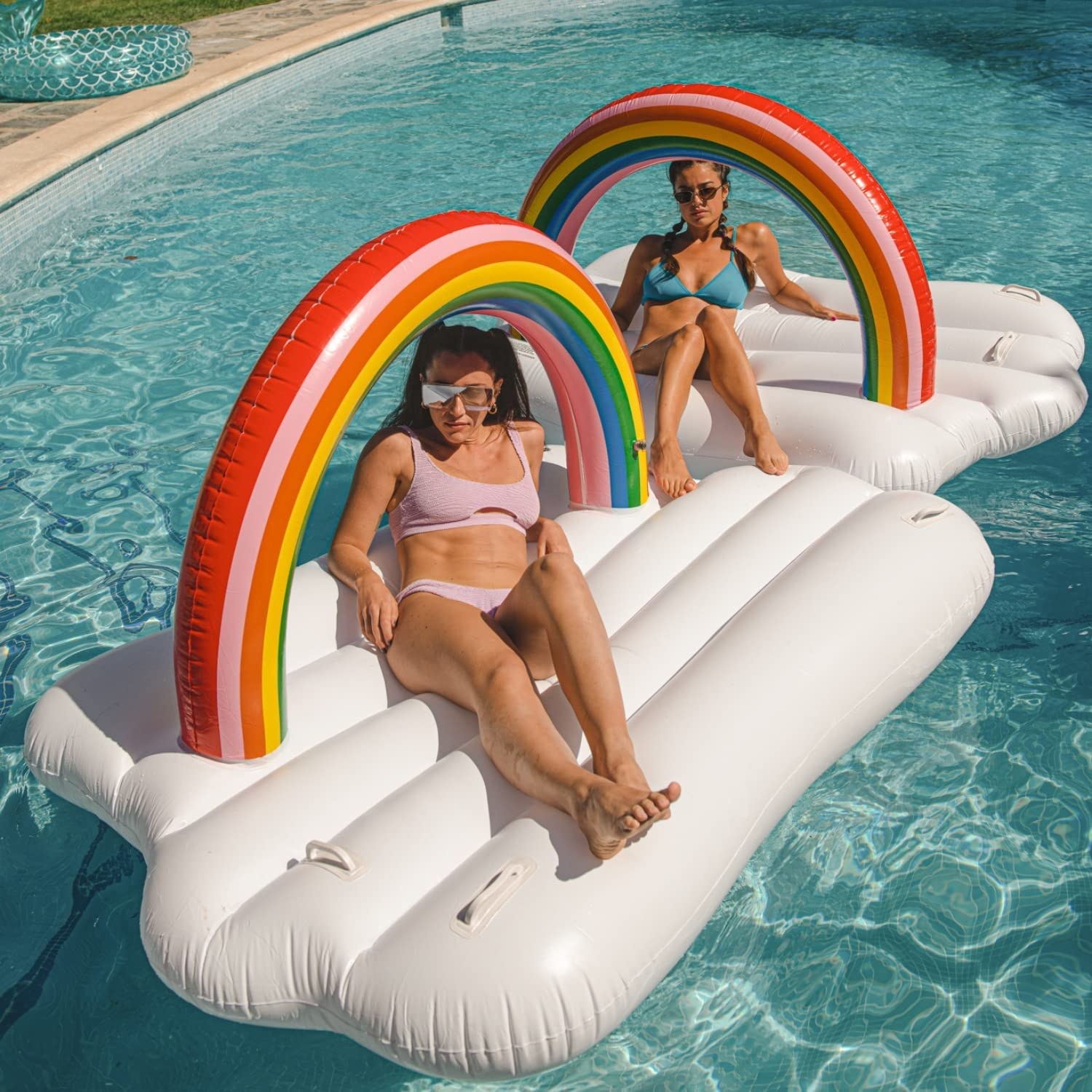 two people using the floats in their pool
