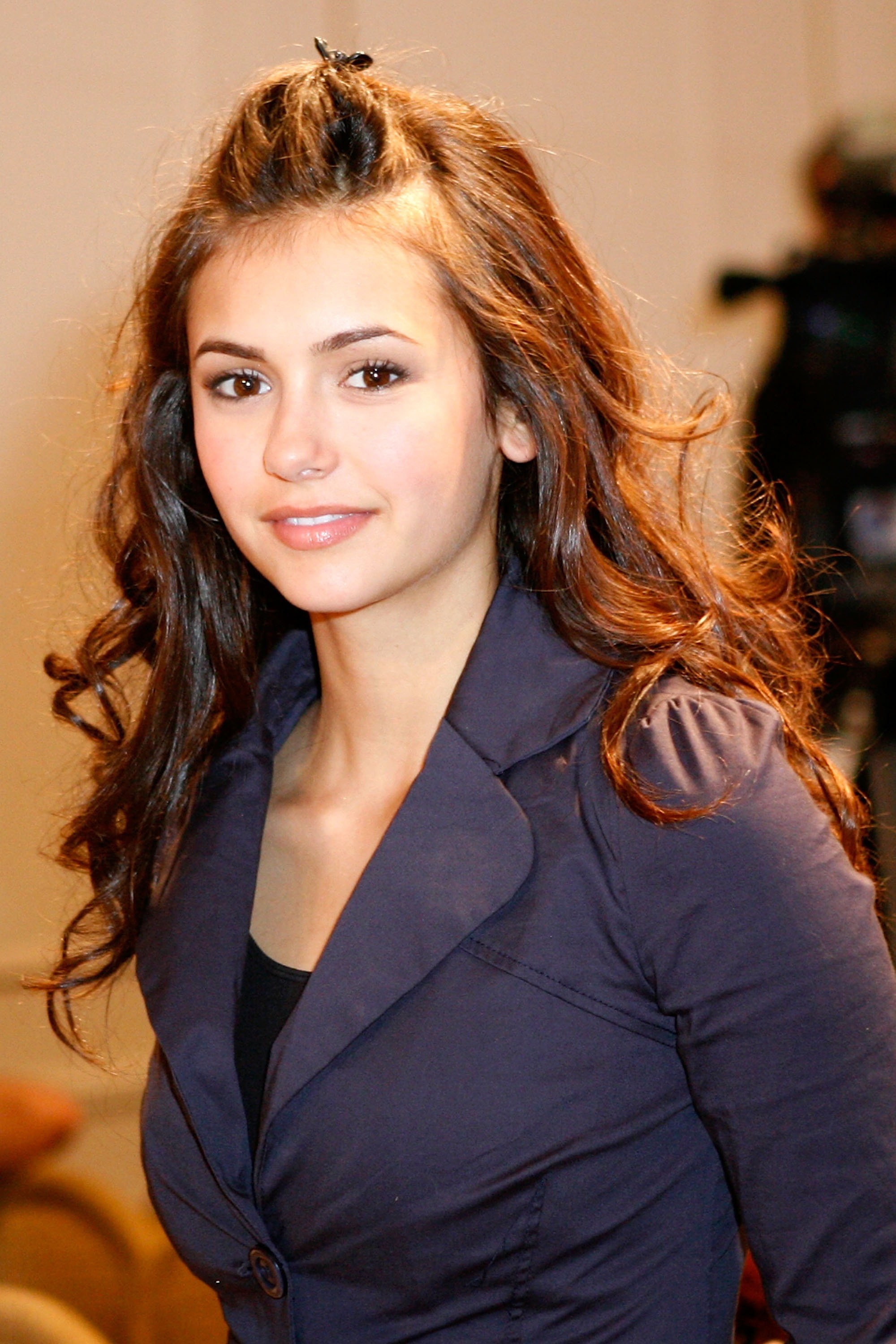 Nina Dobrev smiling at a press conference
